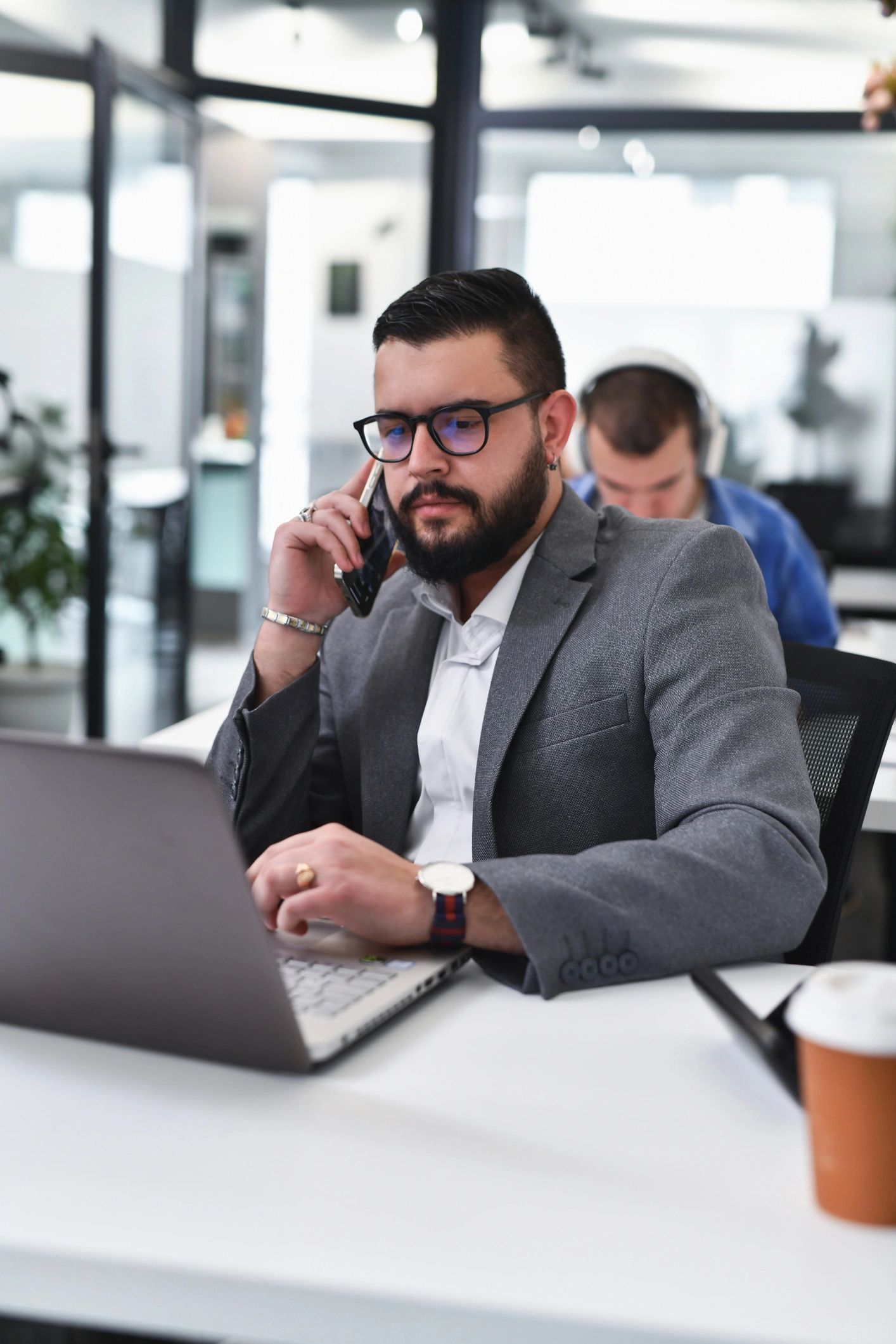 Professional speaking on the phone while reviewing documents